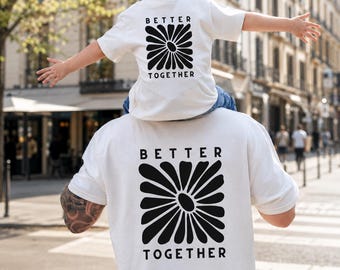 Matching set for dad and child, including a retro flower t-shirt, a trendy family look, and a gift for dad and baby.