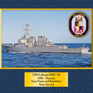 May include: A gray and white warship, the USS Laboon DDG-58, sails on a blue ocean. The ship's crest is visible on the side of the ship, featuring a trident and the words "Without Fear".