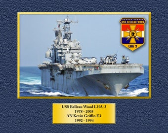 May include: A photograph of the USS Belleau Wood LHA-3, a United States Navy amphibious assault ship. The ship is in the water with a blue sky and white clouds in the background. The ship's name and hull number are visible on the side of the ship. The ship's crest is visible on the right side of the image. The text on the crest reads "USS Belleau Wood, LHA 3".
