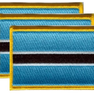 May include: Three rectangular embroidered patches featuring the flag of Botswana. Each patch has a light blue background with a black stripe in the center, a white stripe below, and a gold border.