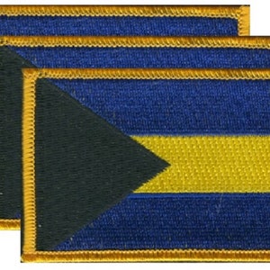 May include: Three embroidered patches with a blue background, a yellow stripe, and a black triangle. Each patch has a gold border. The patches are rectangular in shape.