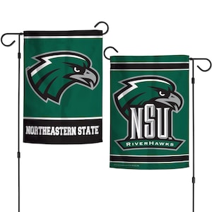 May include: Two green and black garden flags featuring a stylized eagle logo. One flag reads "Northeastern State" in white text. The other flag displays "NSU RiverHawks" with the eagle logo. Both flags are mounted on black metal stands.