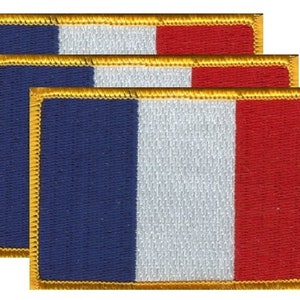 May include: Three rectangular patches featuring the French flag design. Each patch has a blue, white, and red vertical stripe pattern with a gold border. The patches are likely for clothing or accessories.
