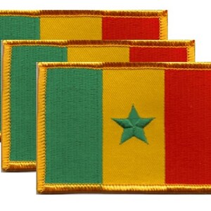 May include: Three rectangular patches featuring the flag of Senegal. Each patch has a green vertical stripe on the left, a yellow center stripe, and a red stripe on the right. A green star is embroidered on the yellow stripe. The patches have gold borders.