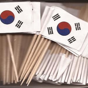 May include: A box filled with small flags of South Korea. Each flag features the Taegeuk symbol in the center, with a red and blue circle, and four black trigrams. The flags are attached to wooden toothpicks.
