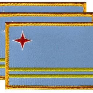 May include: Three embroidered patches featuring the flag of Aruba. Each patch has a light blue background with a red four-pointed star and two yellow horizontal stripes. The edges are trimmed with gold thread.