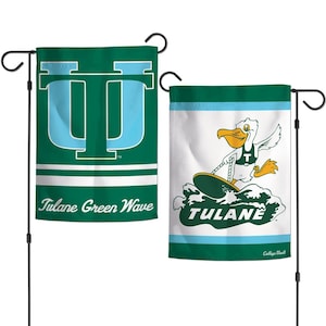 May include: Two green and white Tulane Green Wave garden flags. One flag features a large light blue "U" over a green background. The other flag shows a pelican surfing on a surfboard with the word "TULANE".