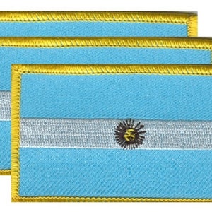 May include: Three embroidered patches featuring the flag of Argentina. Each patch has a light blue background with a white horizontal stripe and a sun emblem. The flag is outlined with gold thread.