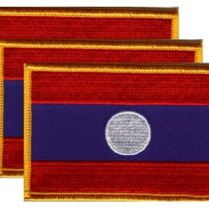 May include: Three rectangular embroidered patches featuring the flag of Laos. Each patch has a red top and bottom stripe, a blue center stripe, and a white circle in the center. The patches are outlined with gold thread.