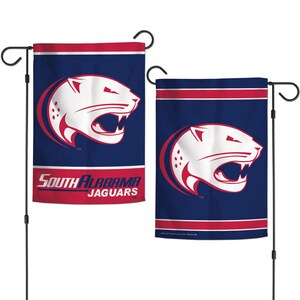 May include: Two garden flags featuring the South Alabama Jaguars logo. The flags have a navy blue background with a white jaguar head and red accents. The text "SOUTH ALABAMA JAGUARS" is displayed on one flag.