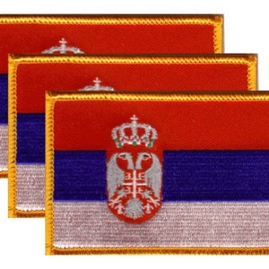 May include: Three embroidered patches featuring the flag of Serbia. Each patch has a red top, blue center, and white bottom, with a gold border. The Serbian coat of arms is centered on the white and blue sections.