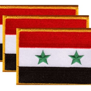 May include: Three embroidered patches featuring the flag of Syria. Each rectangular patch has a red stripe at the top, a white stripe in the middle, and a black stripe at the bottom. Two green stars are centered on the white stripe.