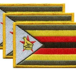 May include: Three rectangular patches featuring the flag of Zimbabwe. The flag design includes horizontal stripes of yellow, red, black, and yellow, with a white triangle on the left side. The triangle contains a red star and a yellow bird emblem.