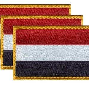 May include: Three rectangular patches featuring the flag of the Netherlands. Each patch has a red stripe at the top, a white stripe in the middle, and a dark blue stripe at the bottom. The edges are trimmed with gold.