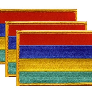 May include: Three rectangular patches with a red, blue, yellow, and green striped design. Each patch has a gold border. The patches are arranged in a slightly overlapping pattern, showcasing the design.