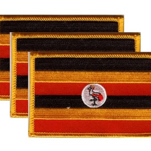 May include: Three rectangular patches featuring the flag of Uganda. The flag design includes horizontal black, yellow, and red stripes, with a white circle in the center displaying a grey crowned crane. The patches have a gold border.