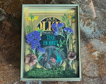 Vintage hobbit book cover in a vintage brass frame with real dried flowers and mushrooms