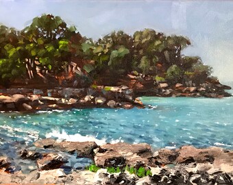 May include: A painting of a rocky coastline with a small cove of blue water. The water is sparkling and there are trees on the cliffside.