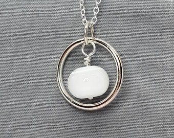 Silver circle of life pendant with white glass bead accent