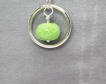 Silver circle of life pendant with a beautiful green glass bead