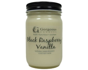 May include: A glass jar candle with a black lid. The candle is labeled "Gorgeous Candles" and "Black Raspberry Vanilla". The candle is natural hand poured and made with 12oz soy wax.