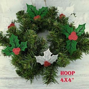 May include: Four embroidered holly sprigs with red berries. Two sprigs are green and two are white. The sprigs are arranged on a green artificial evergreen wreath. The text "HOOP 4X4" is printed below the wreath.