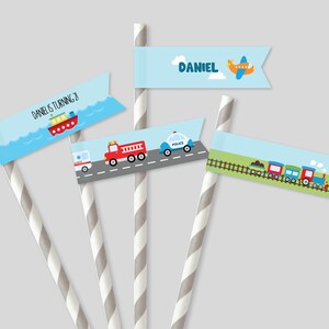 May include: Set of five blue and white paper straw flags with different transportation themes. The flags feature a boat, a fire truck, a police car, a train, and an airplane. One flag says "Daniel is turning 2". Another flag says "Daniel".
