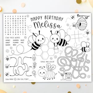 May include: Black and white activity sheet for a birthday, featuring bees, a honeycomb, and mazes. The sheet includes the text "Happy Birthday Melissa", a word search, and a tic-tac-toe game. There are also instructions to trace and colour.