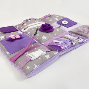 Sensory mat details in different texture for tactile stimulation: Zipper, plastic buckle, different button and ribbons, felt decoration, pocket, ties, snap button, and other sensory texture