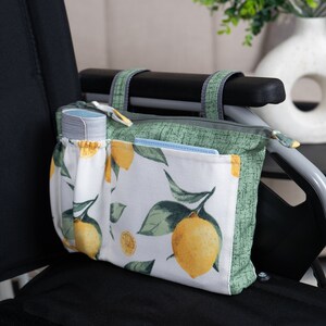 May include: A white and green zippered pouch with a lemon print. The pouch has multiple pockets and is hanging on the armrest of a wheelchair.
Wheelchair Armrest Bag, Walker Side Bag with Zippered Top, Small Walker Bag, Rollator Pouch, Powerchair Organizer, Wheel chair Accessories