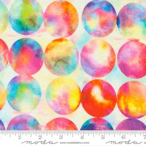 May include: A white fabric with a repeating pattern of colorful, watercolor-style circles. The circles are in shades of pink, blue, yellow, and green. The fabric is from Moda Fabrics.