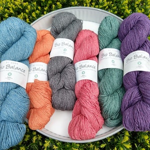 May include: Six skeins of yarn in various colors, including teal, purple, coral, gray, and blue. Each skein is labeled "Bio Balance" with the text "100% Pure Organic Wool" and "BC Garn" on the label.