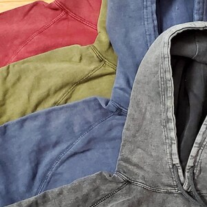 May include: Five hooded sweatshirts in different colors, including red, green, blue, and gray. The sweatshirts are made of a soft, comfortable fabric and have a relaxed fit.