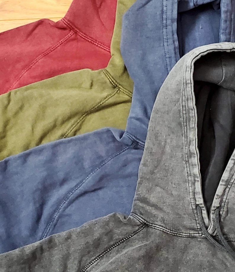 May include: Five hooded sweatshirts in different colors, including red, green, blue, and gray. The sweatshirts are made of a soft, comfortable fabric and have a relaxed fit.