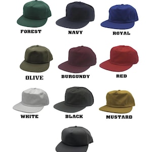 May include: A collection of ten baseball caps in various colors, including forest green, navy, royal blue, olive, burgundy, red, white, black, mustard, and dark grey. Each cap has a flat brim and a structured crown, with the color name displayed below.