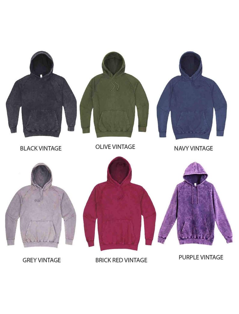 May include: Six different color vintage hoodies. The hoodies are in black, olive, navy, grey, brick red, and purple. Each hoodie has a drawstring hood and a kangaroo pocket.