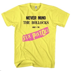 May include: Yellow t-shirt with black text that reads "Never Mind The Bollocks Here's The Sex Pistols" with a pink diagonal band across the text.