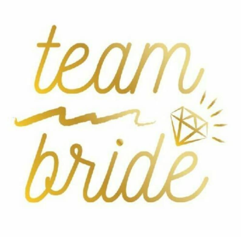 May include: Gold foil sticker with the text "team bride" and a diamond graphic.