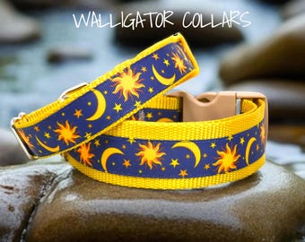 May include: Two dog collars with a celestial design. The collars are yellow with a navy blue band featuring suns, moons, and stars. The text "WALLIGATOR COLLARS" is at the top. One collar is buckled, and the other is unbuckled.