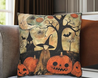 May include: Square decorative pillow with a Halloween-themed design. The artwork features a witch, jack-o'-lanterns, a haunted house, and a tree with a full moon in the background. The color palette includes orange, black, and beige.