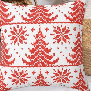 May include: Red and white cushion with a knitted pattern of snowflakes and Christmas trees.