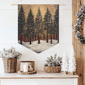 May include: A wintery forest scene with snow-covered hills and a golden sky. The trees are dark green and the snow is white. The scene is painted on a canvas and is hanging on a white wall.