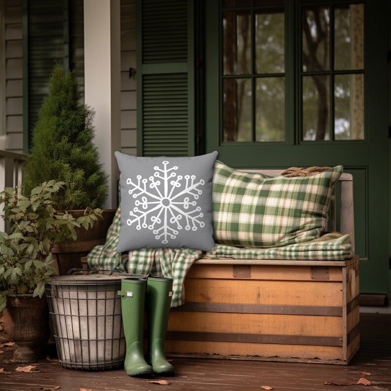 This festive winter pillow covers features a large snowflake on a gray background. A perfect addition to your holiday decor and into the late winter months.