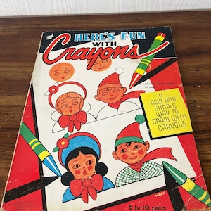 May include: A red and black coloring book with the title "Here's Fun with Crayons". The cover features illustrations of children with red, white, and blue clothing. The book is for ages 6 to 10 years.