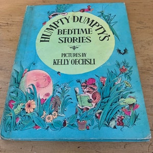 May include: A vintage children's book titled "Humpty Dumpty's Bedtime Stories" by Kelly Oechsli. The cover features a light blue background with illustrations of a smiling egg, a raccoon reading, and various plants and insects.