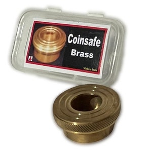May include: A brass coin safe with a clear plastic storage case. The case has a label that reads "Coinsafe Brass" and "Made in India".
