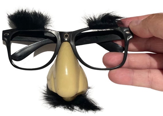 Closeup Of A Fake Nose And Glasses With Furry Eyebrows Stock Photo