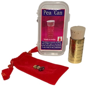 May include: A magic trick kit called "Pea Can" in a clear plastic case with a gold metal cylinder and a red velvet bag with a few peas inside. The case has a label that says "Made in India" and describes the trick.