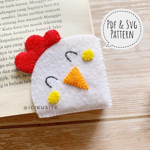 May include: A white felt chicken bookmark with a red comb, orange beak, and yellow accents. The bookmark is on a book page. Text on the image says "PDF & SVG PATTERN" and "@ICIKUSITE".