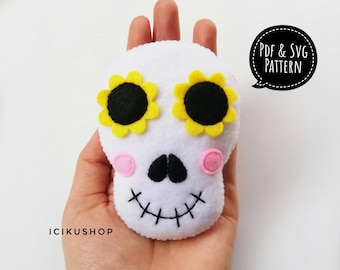 May include: White felt skull with black eyes, pink cheeks, and a stitched smile. The skull has yellow felt sunflowers with black centers for eyes.  PDF & SVG PATTERN.